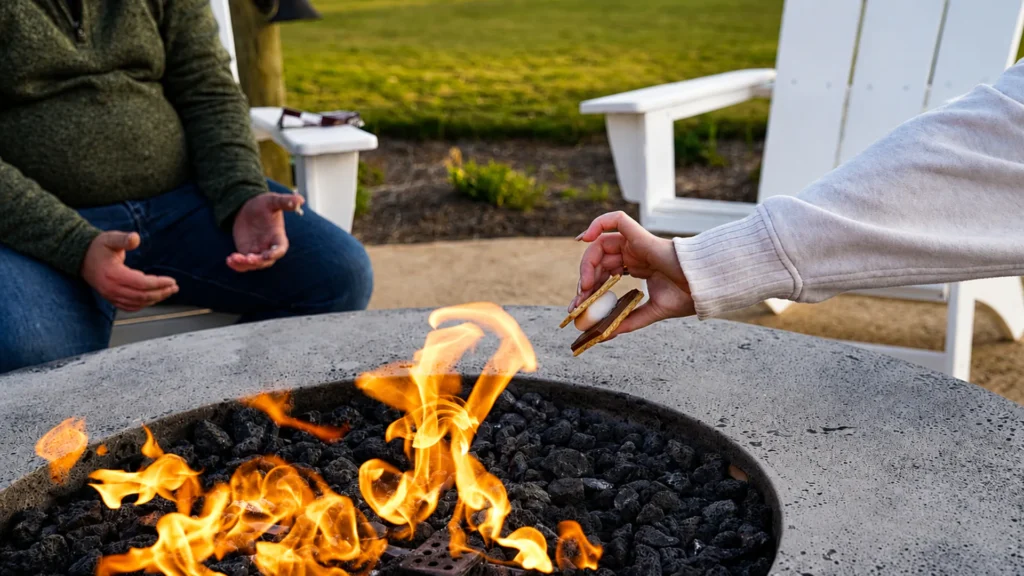 Guests making s'mores at a Tropic Hideaway fire pit